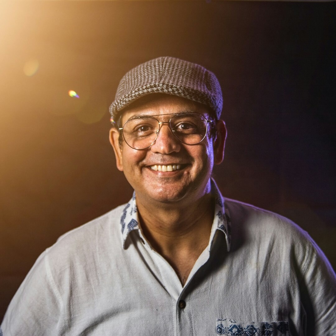 Professional headshot of a man in his 50s with glasses in business attire