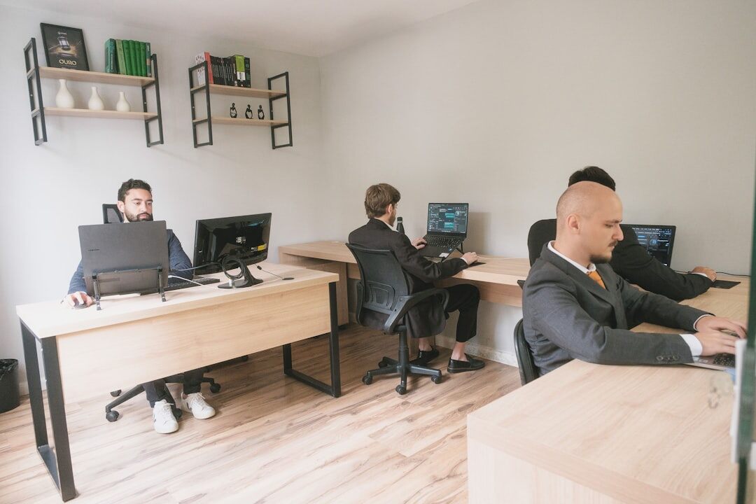 Startup team working together at a modern office desk with laptops